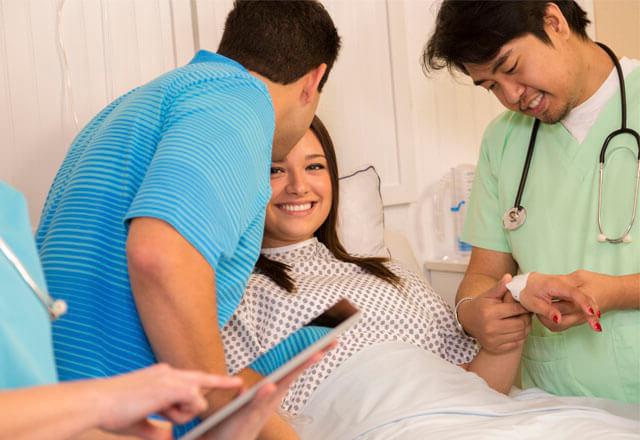 physician checking the pulse of an adult patient